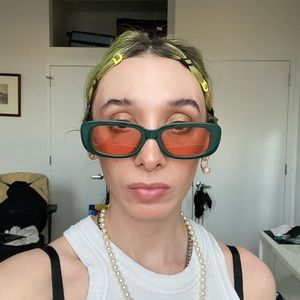 Pink tinted glasses with forest green frames